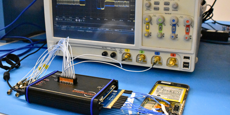 Engineer preparing oscilloscopes and probes in a lab